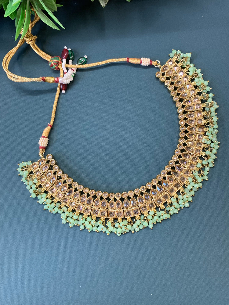 Rashmeet polki necklace with matching earring tikka antique gold mint green