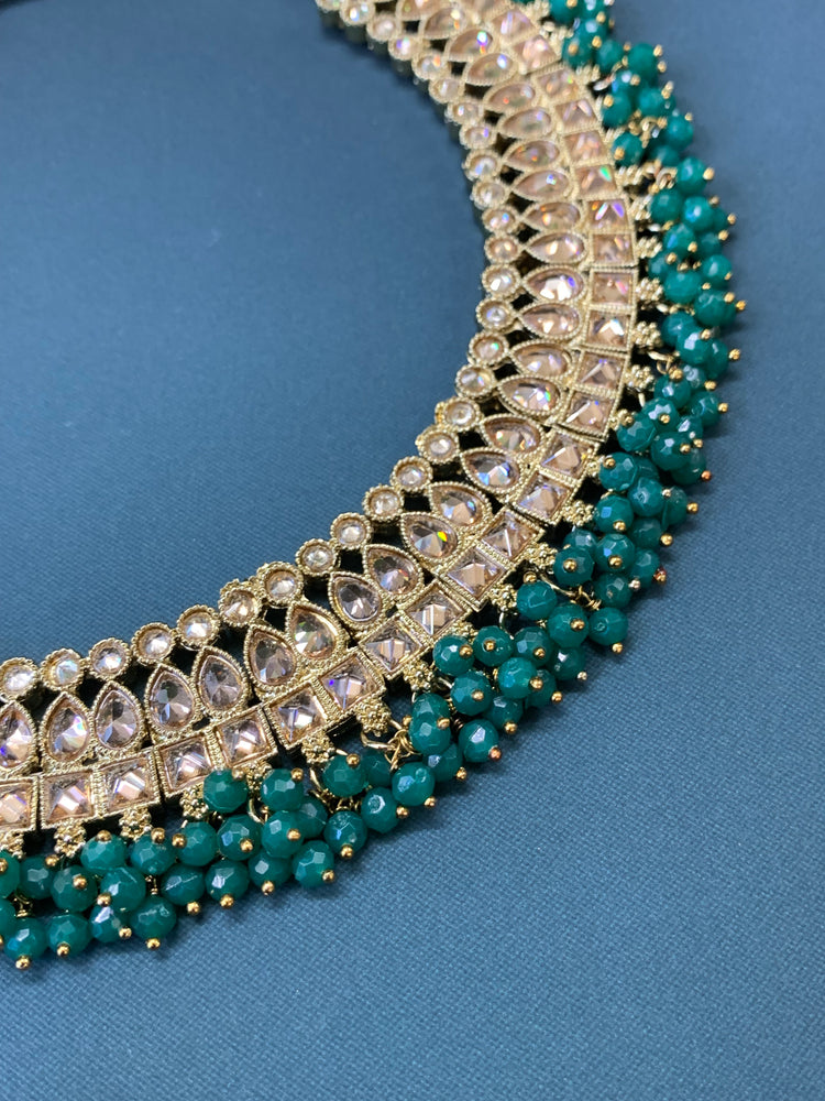 Rashmeet polki necklace with matching earring tikka antique gold emerald green