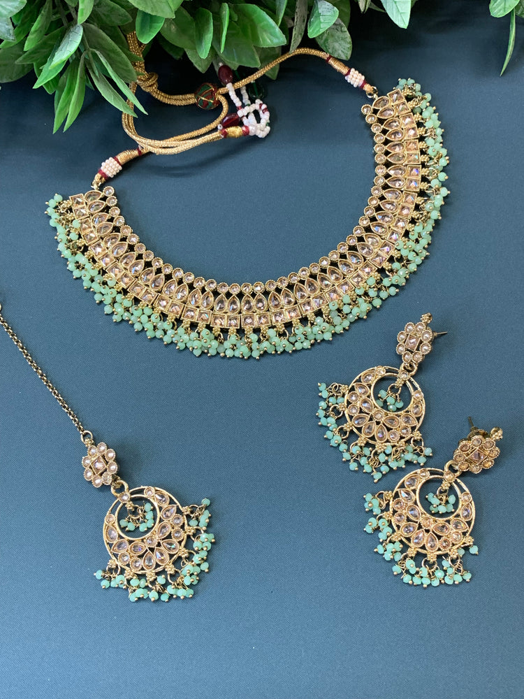 Rashmeet polki necklace with matching earring tikka antique gold mint green