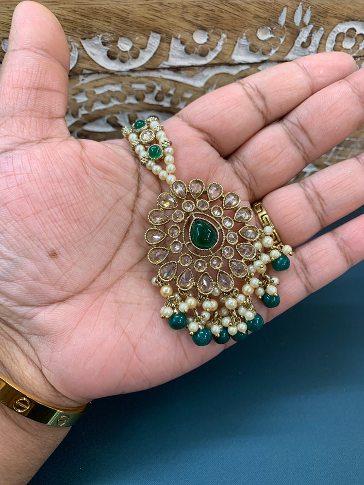 Shana triple layer bahubali sahare jhumki ear chain and matching tikka antique gold /emerald green